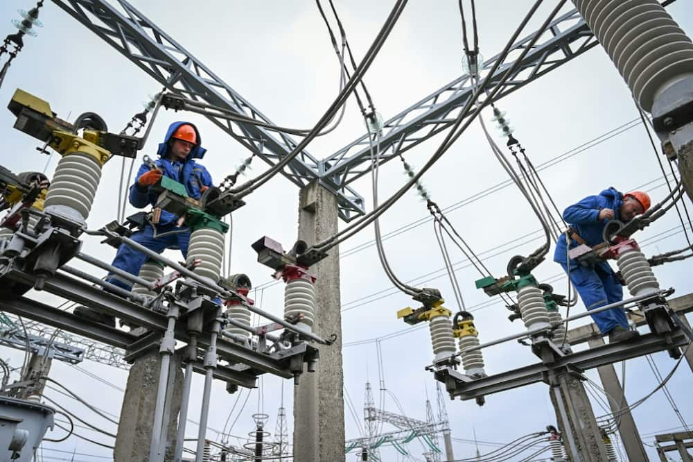 Keeping the lights on: electricians work on power lines near Balti, Moldova