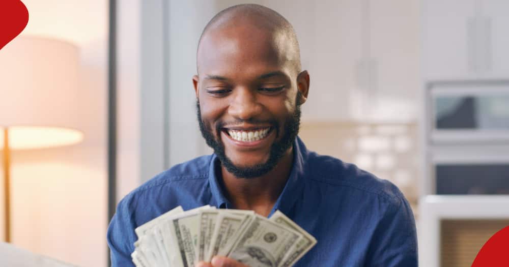 A man with US dollars smiles.