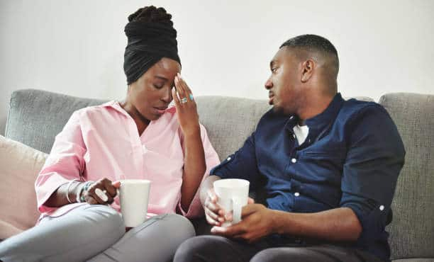 Frustrated woman having tea with husband. Photo for illustration.