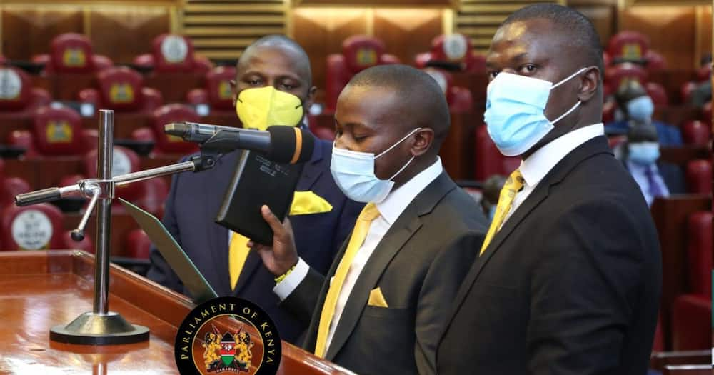 UDA MPs Kimani Ichungwa'h and Ndindi Nyoro flank Kiambaa MP John Njuguna during the swearing-in ceremony.