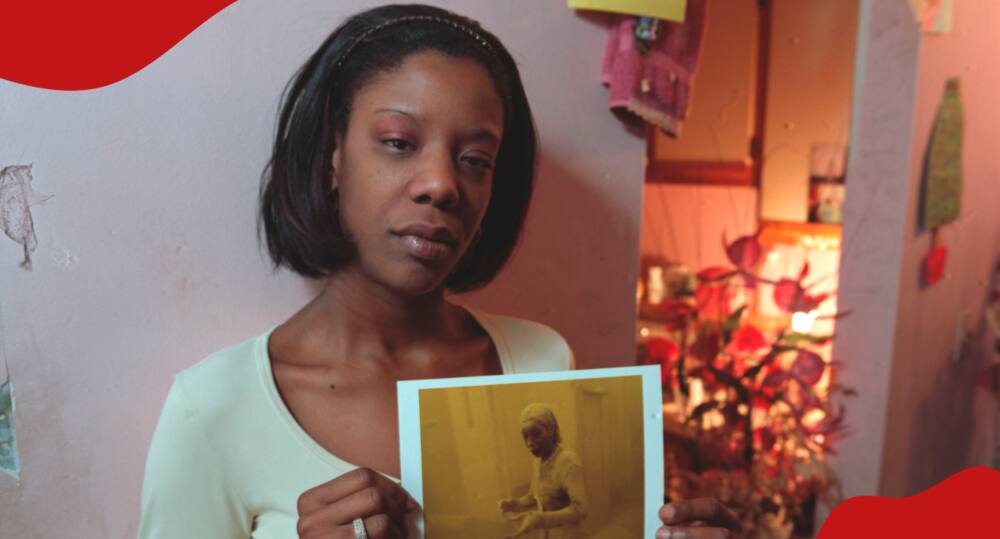 Marcy Borders holds her iconic photo in 2001.