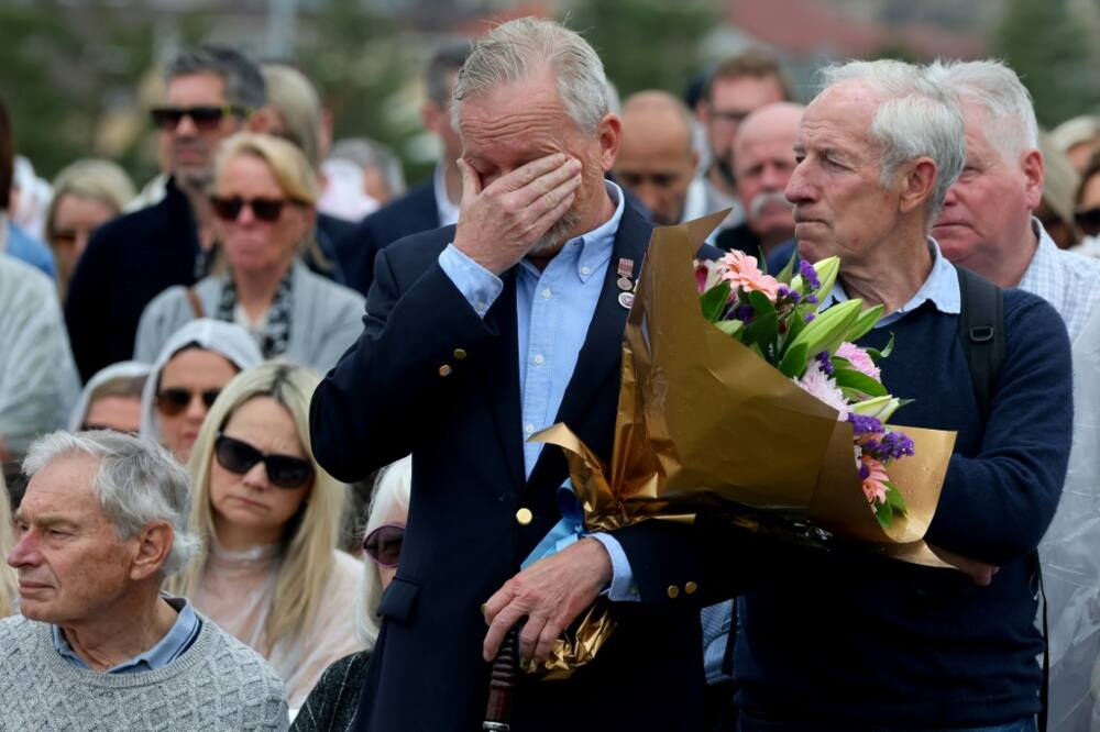 People attend a commemoration ceremony to mark the 20th anniversary of the Bali bombings at Sydney's Coogee Beach