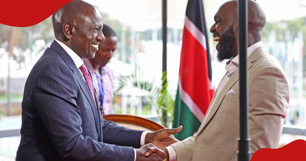 William Ruto and Larry exchange pleasantries.
