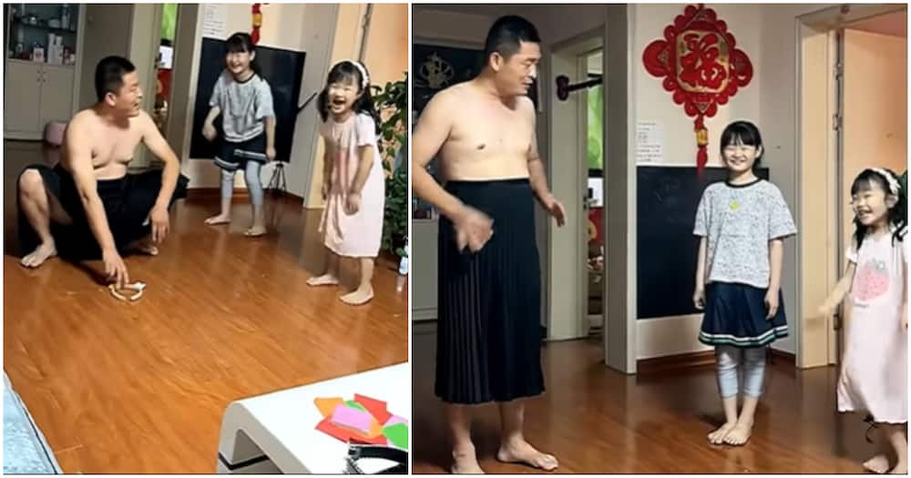 Chinese dad teaching his daughters proper etiquette in a dress.