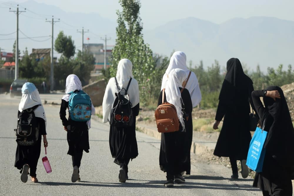 Girls walk to school along in Gardez