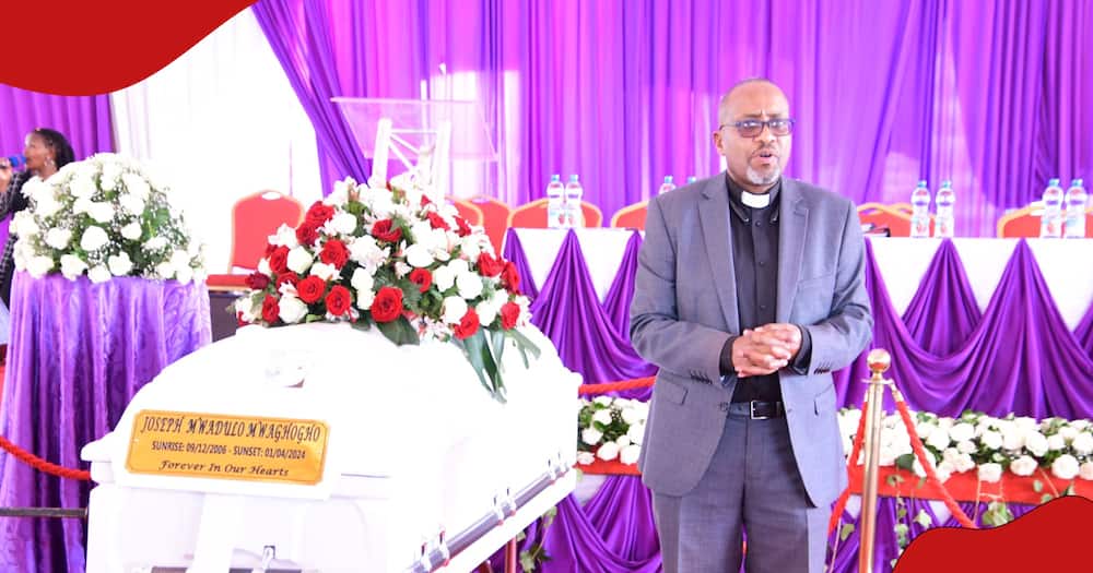 A preacher stands next to Joe Mwadulo's casket.