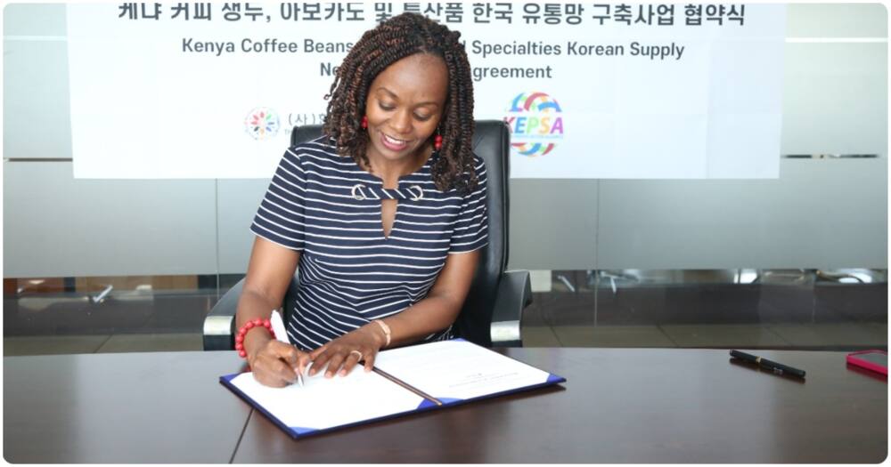 KEPSA CEO Carole Kariuki signs a document.