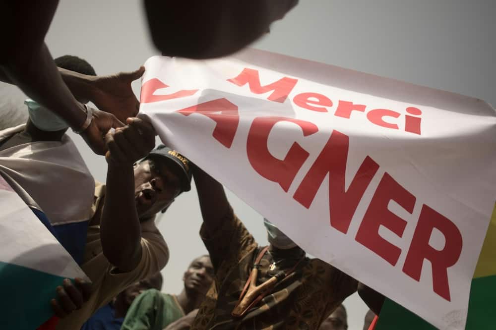 Protesters hold a banner reading 'Thank you Wagner', the name of the Russian private security firm present in Mali