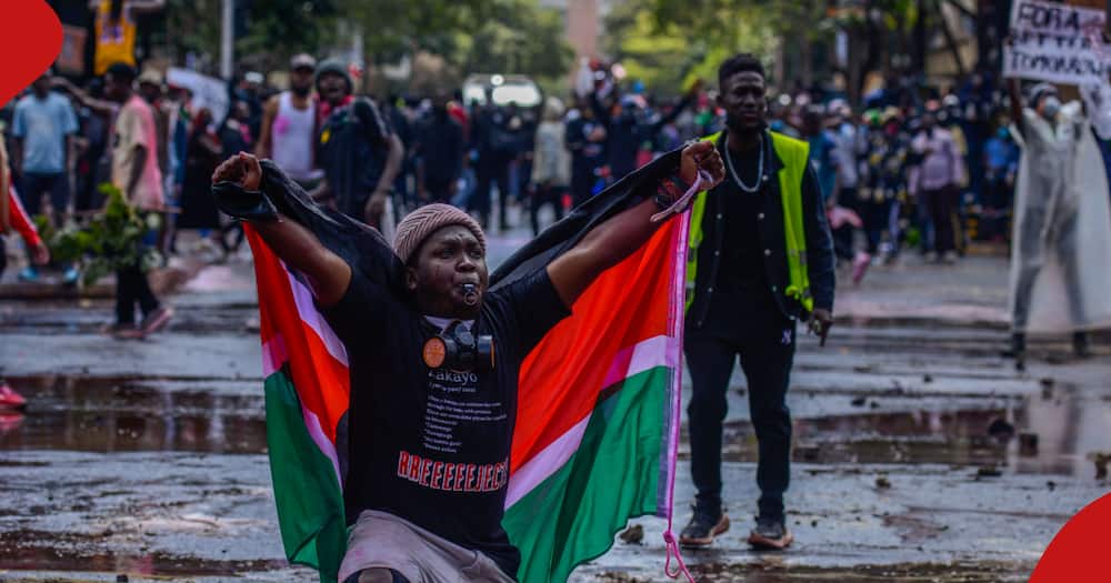 A Kenyan man holds the country's flag during protests in Nairobi against tax hikes.
