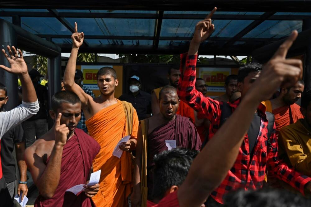 Demonstrators shout slogans against interim Sri Lanka President Ranil Wickremesinghe during a protest in front of the Fort railway station in Colombo on July 19, 2022