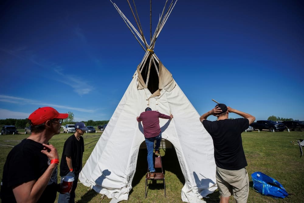 Volunteers on June 7 assemble a teepee in Maskwa Park in Maskwacis, Alberta ahead of Pope Francis's historic end of July visit to Canada in which he is to offer apologies for more than a century of abuses at Indigenous residential schools