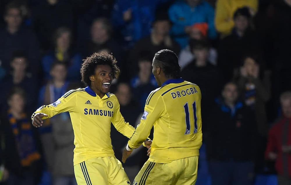 Didier Drogba celebrating with former teammate Willian during Chelsea's Capital One Cup Fourth Round clash vs Shrewsbury Town. Photo by AMA/Corbis.