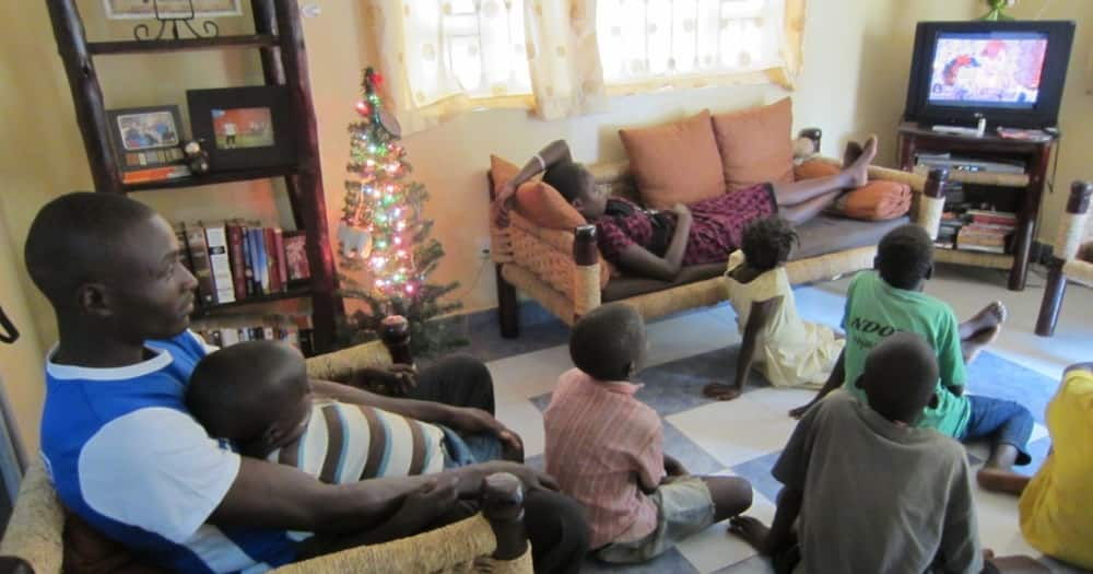 A family watching TV. Photo: Coca-Cola.