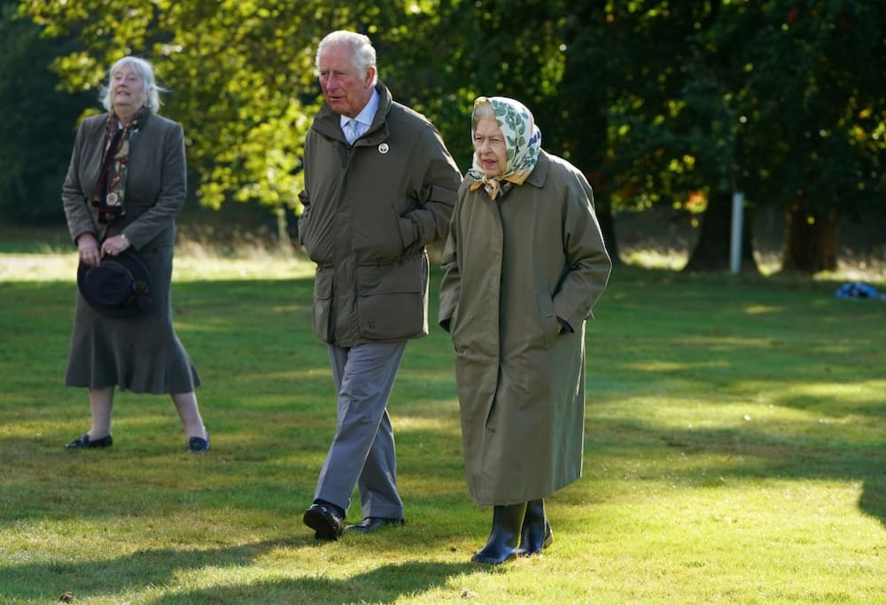 The queen and the then Prince Charles strolling through the grounds at Balmoral last year
