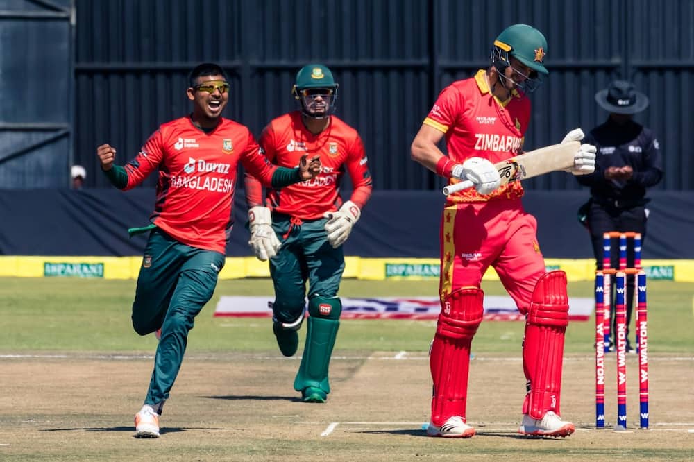 Bangladesh bowler Mosaddek Hossain (L) celebrates taking the wicket of Zimbabwe captain Craig Ervine (R) during the second Twenty20 cricket international at Harare Sports Club on July 31, 2022.