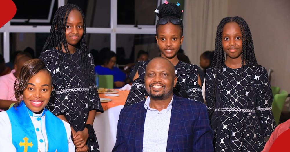 Mary Lincon (in white and blue dress) poses for a photo with CS Moses Kuria (r) and her three daughters (standing).