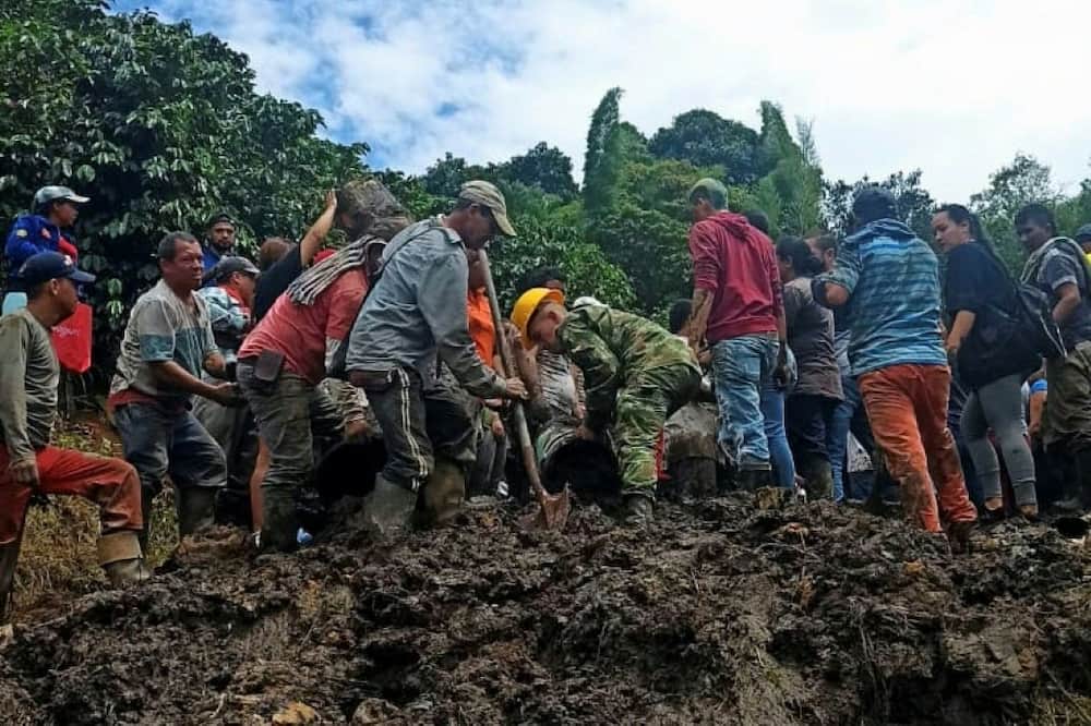 Villagers are digging through the rubble where at least eight children are believed to be trapped after a landslide buried a school