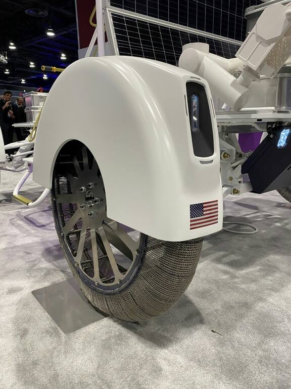 Dynetics' prototype, which will achieve a top speed of nine miles per hour (15 kph), includes a robotic arm and metal wheels that are braided like textiles, to maximize traction on the sandy surface and deal with any rocks they encounter