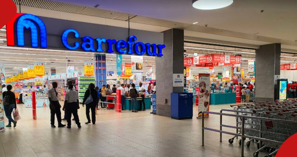 Shoppers walk into a Carrefour shopping hall.