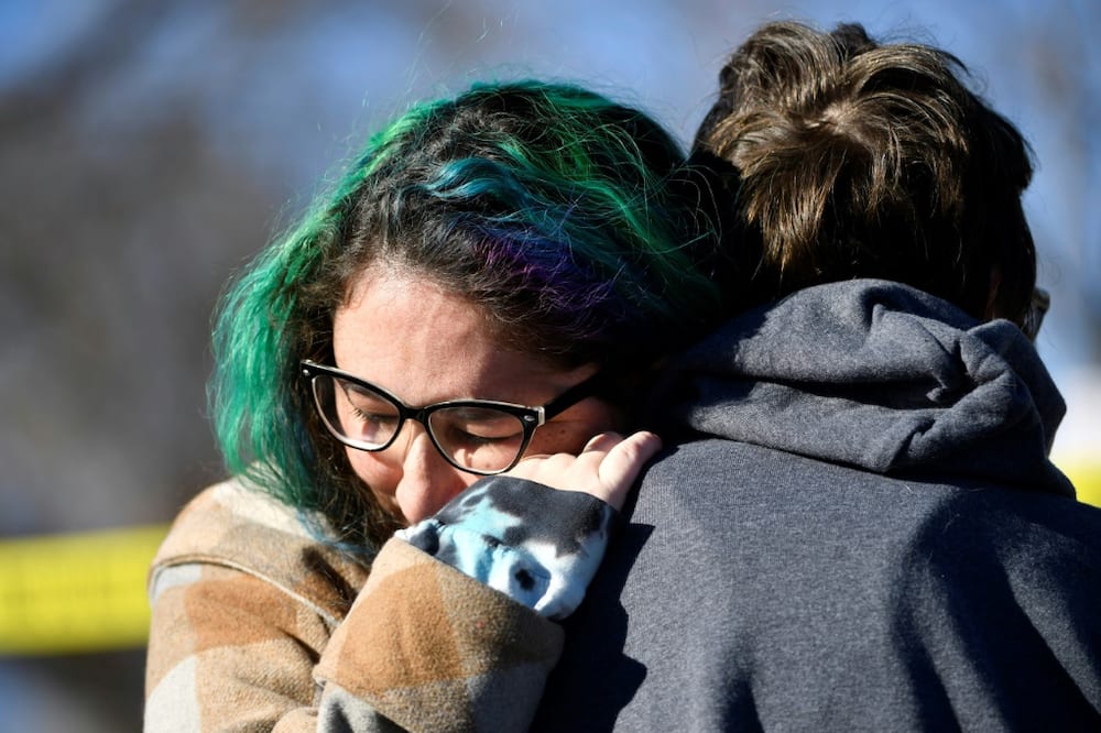 Jessy Smith Cruz (L) embraces Jadzia Dax McClendon the morning after the shooting at Club Q in Colorado Springs