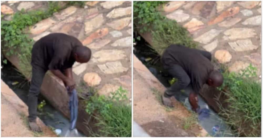Man washing his clothes in a gutter