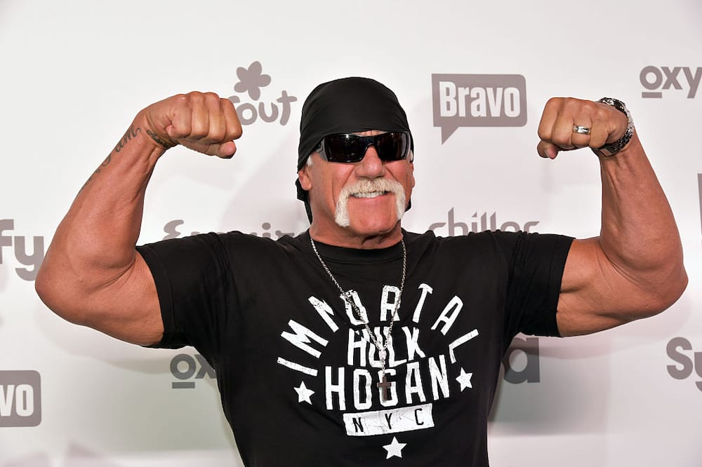 Retired professional wrestler Hulk Hogan flexing while posing for a photo