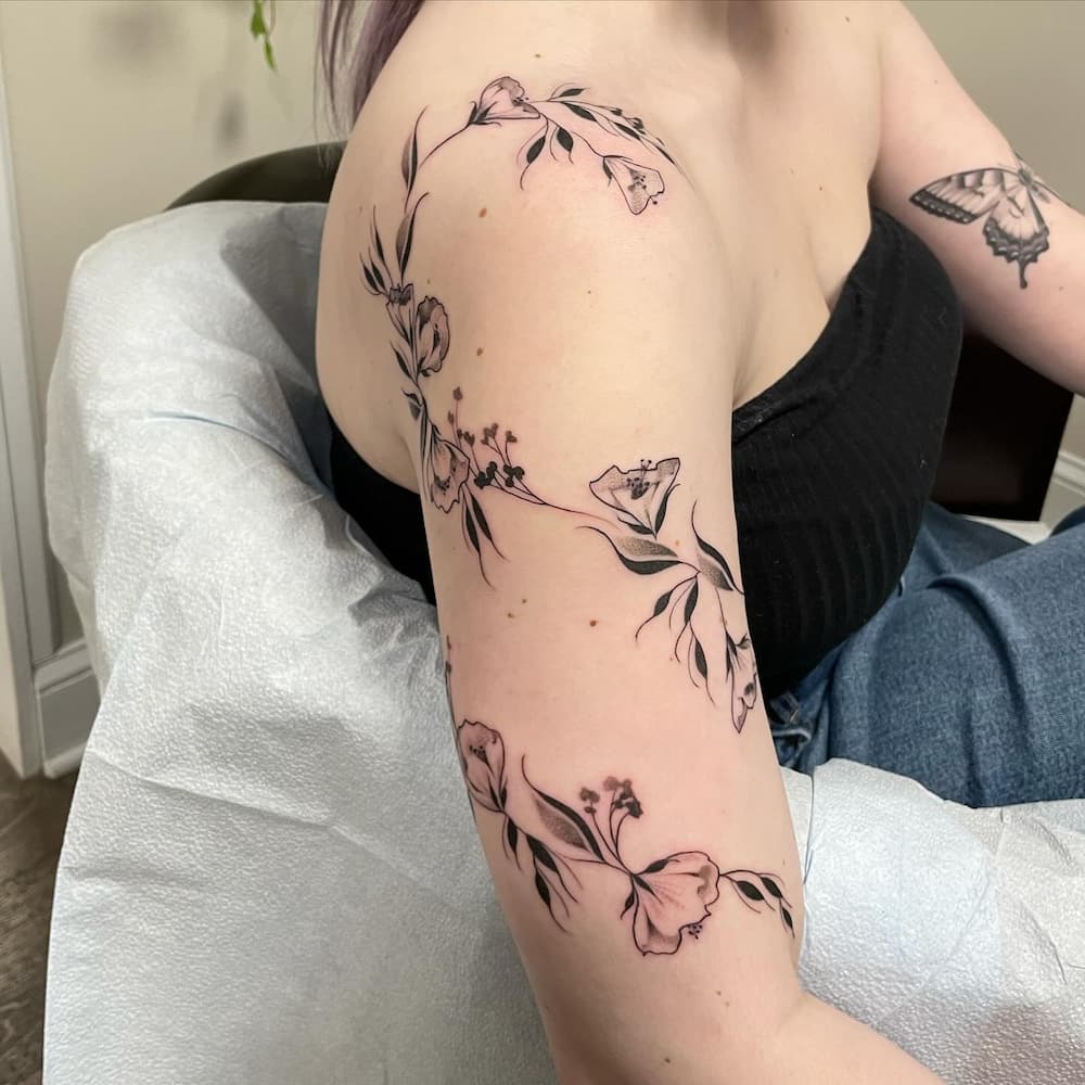 Arm tattoo of climbing lilly vines