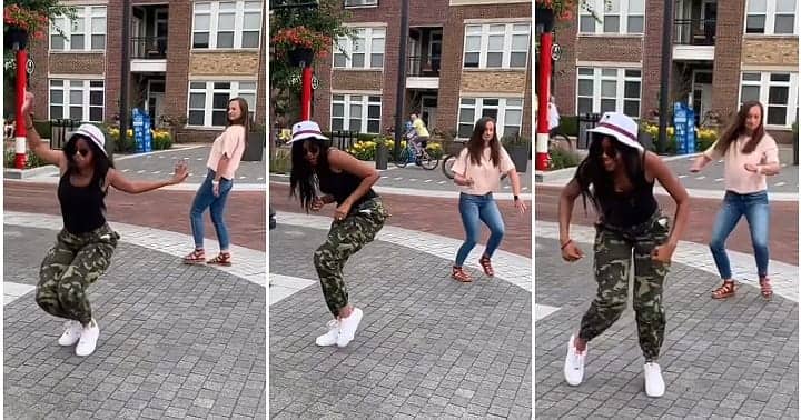 Oyinbo woman dances with black lady, camo trousers