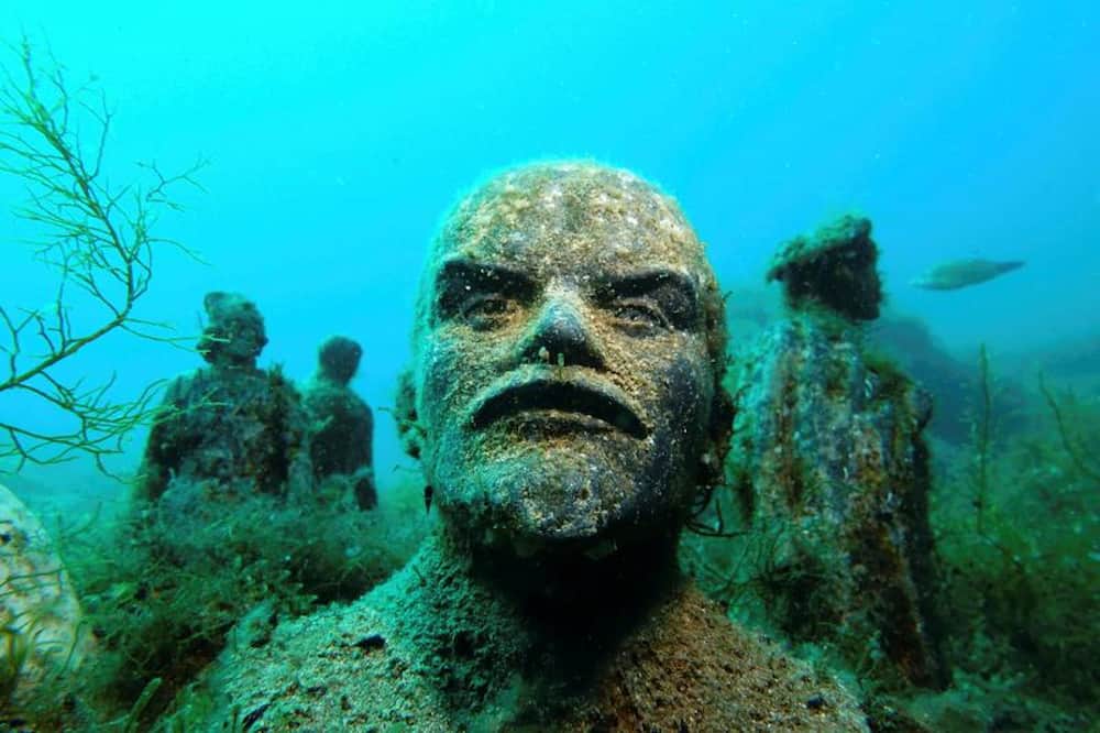 scary underwater statues