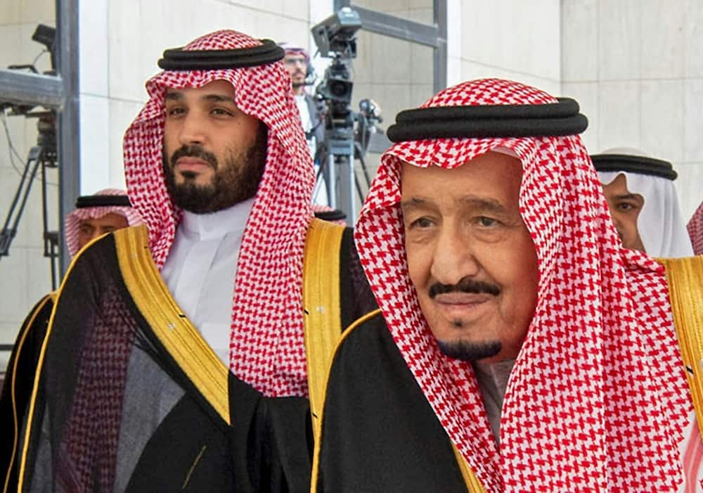 This handout picture provided by the Saudi Royal Palace on November 20, 2019 shows Saudi Arabia's King Salman bin Abdulaziz, on the right, arriving with Crown Prince Mohammed bin Salman to address the Shura council in Riyadh