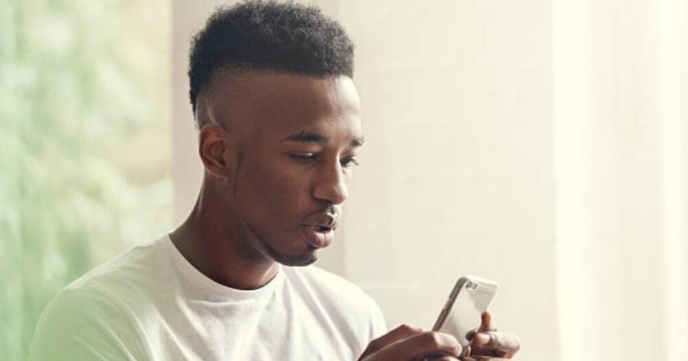 A man checking his mobile phone.