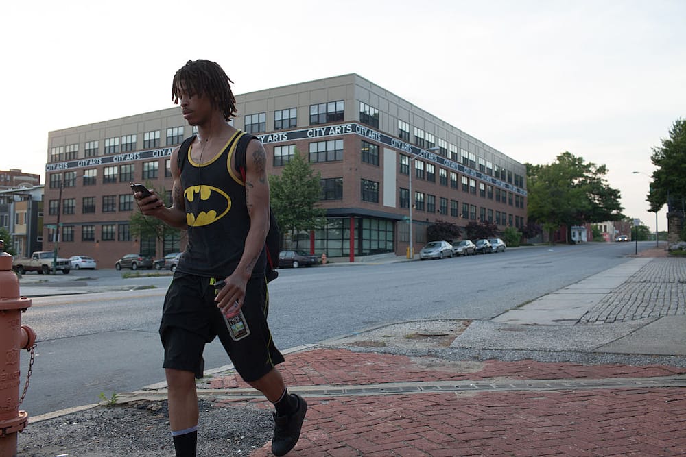A man walking in Greenmount East, Baltimore