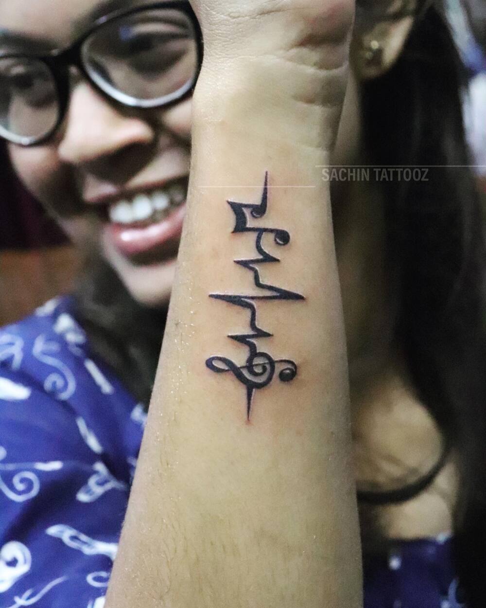 Women's music tattoo