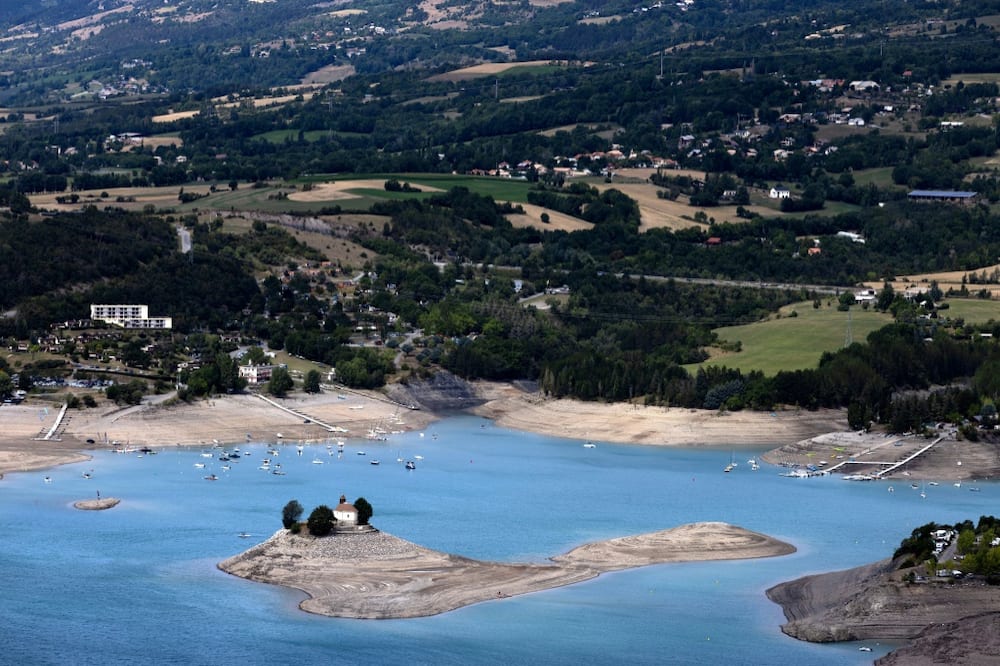 The Saint-Michel Chapel on a small island in the Serre-Poncon lake in the French Alps is seen in August 2022 after drought pushed down the the water level by 14 meters amid rising global concerns on climate change