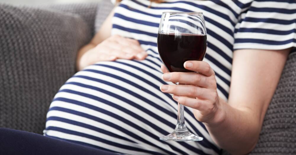 Close up of pregnant woman drinking red wine. Photo: Getty Images.