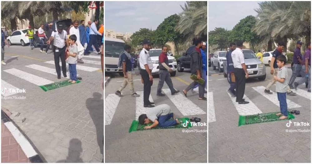 Little boy prays in middle of the road, mat, traffic