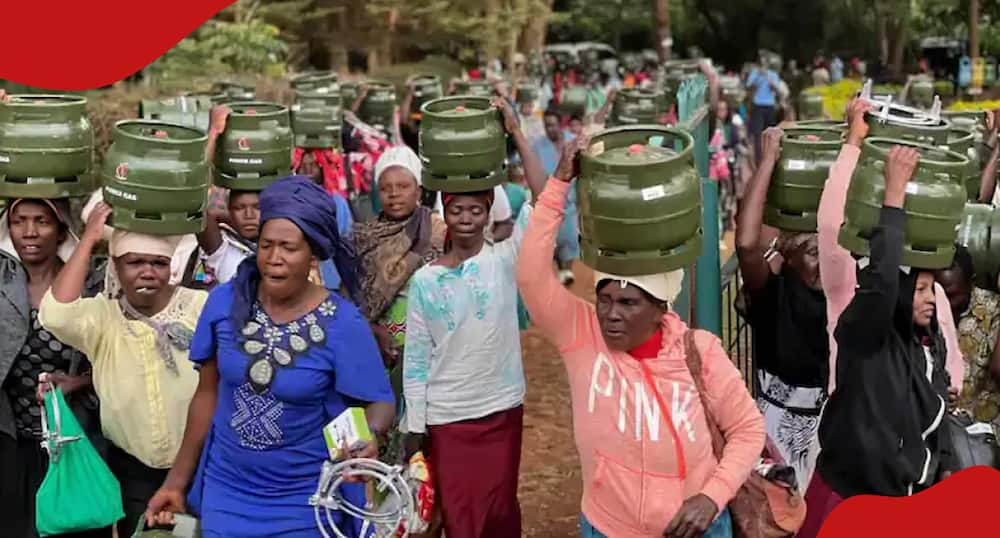 Women carrying donated gas cylinders