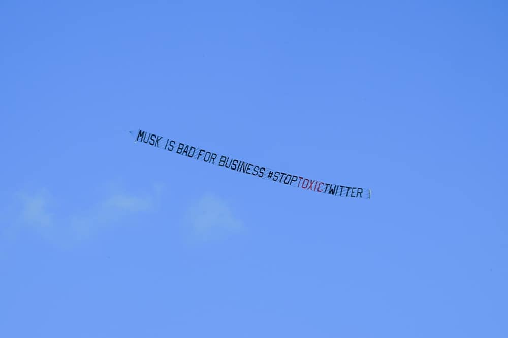 A banner reading, "Musk is Bad for Business #StopToxicTwitter" is flown over a conference venue in Miami, Florida where the Twitter CEO made a keynote address