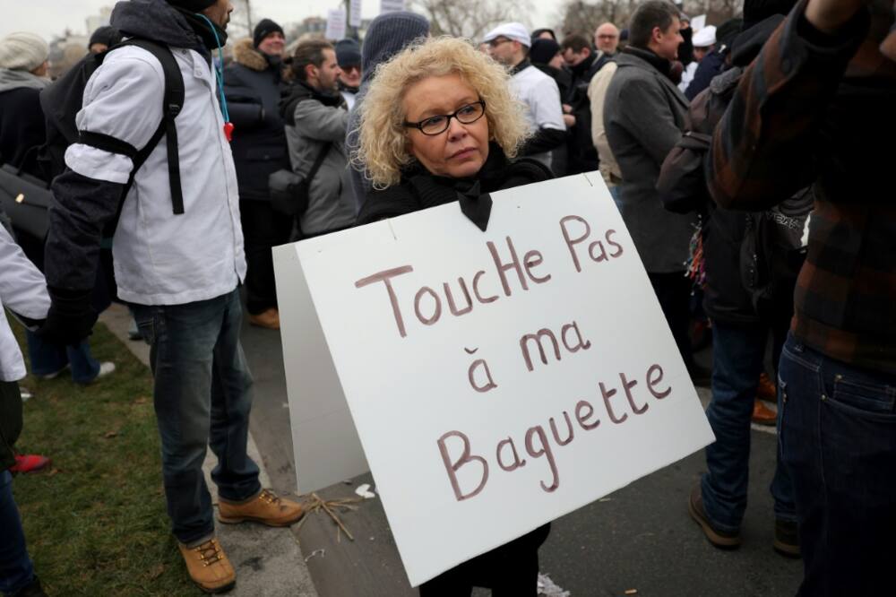 Joelle Reimel, a 56-year-old baker with nearly 30 years experience, wore a sign around her neck that read:  'Don't touch my baguette'.