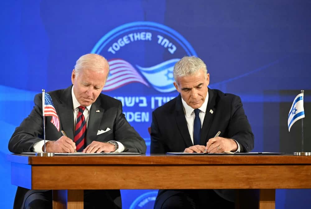 US President Joe Biden  and Israel's caretaker Prime Minister Yair Lapid sign a security pledge in Jerusalem on July 14