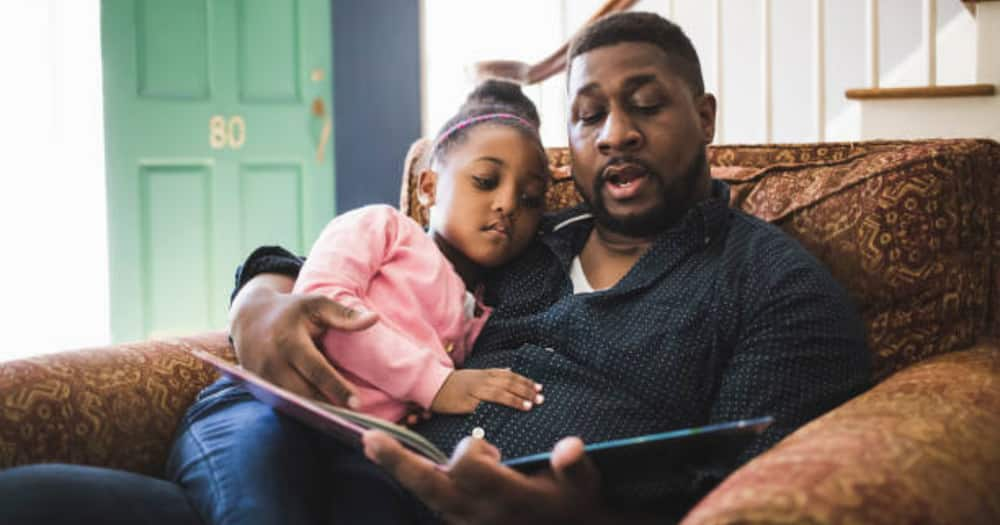 Father and daughter reading. Photo for illustration.