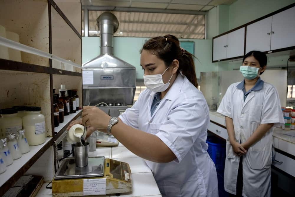 Lab technicians check the quality of latex at the VA Latex rubber factory in Trang province
