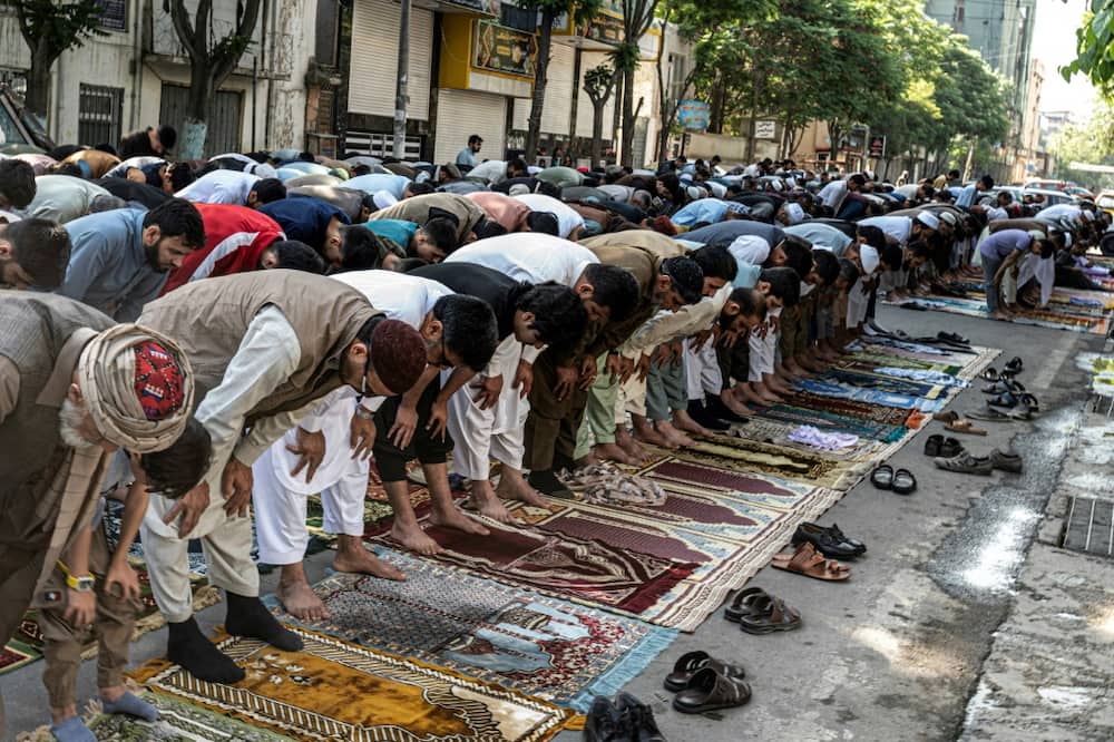 Muslim devotees offering Eid al-Fitr prayers, which marks the end of the holy fasting month of Ramadan outside a mosque in Kabul earlier this year