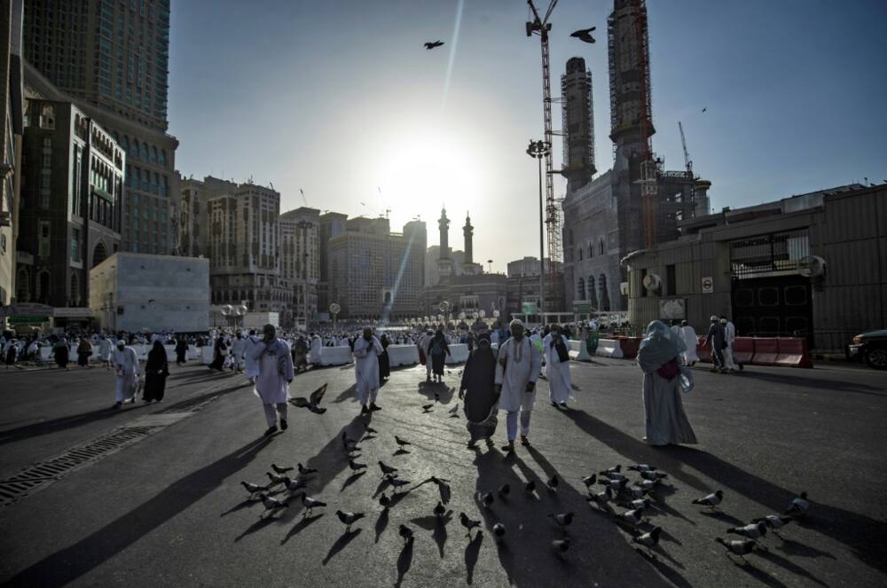 Pilgrims, pictured outside the Grand Mosque in Mecca, say they are enduring the heat because of their faith in God