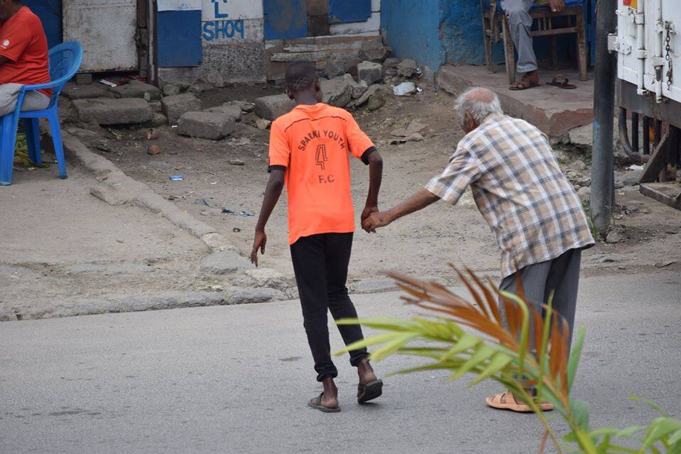 Mombasa boy warms hearts after putting bicycle aside to help elderly man cross road