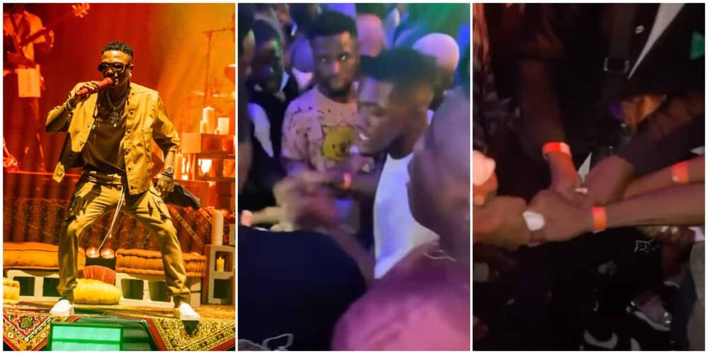 Men burn and share Wizkid's sweaty towel after catching it during his performance in Warri, video stirs reactions.