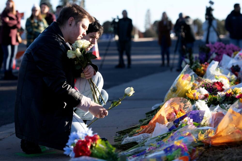 Ren Kurgis (left) and Jessie Pacheco pay their respects to victims of the mass shooting at Club Q in Colorado Springs