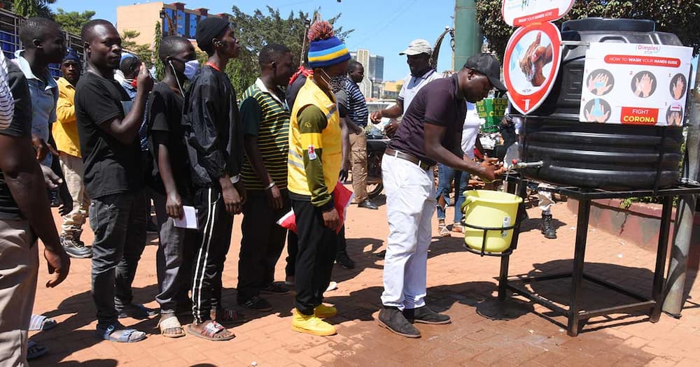 Farouk Mujumba (washing hands) is a Uganda-based businessman.