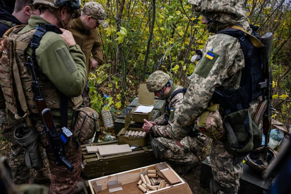 Ukrainian servicemen check their ammunition at a position on the front line in eastern Ukraine's Donetsk region