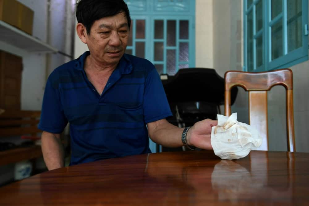 Resident Tran Minh Hoang wrapped his home in netting to keep out the dust, but it still gets in